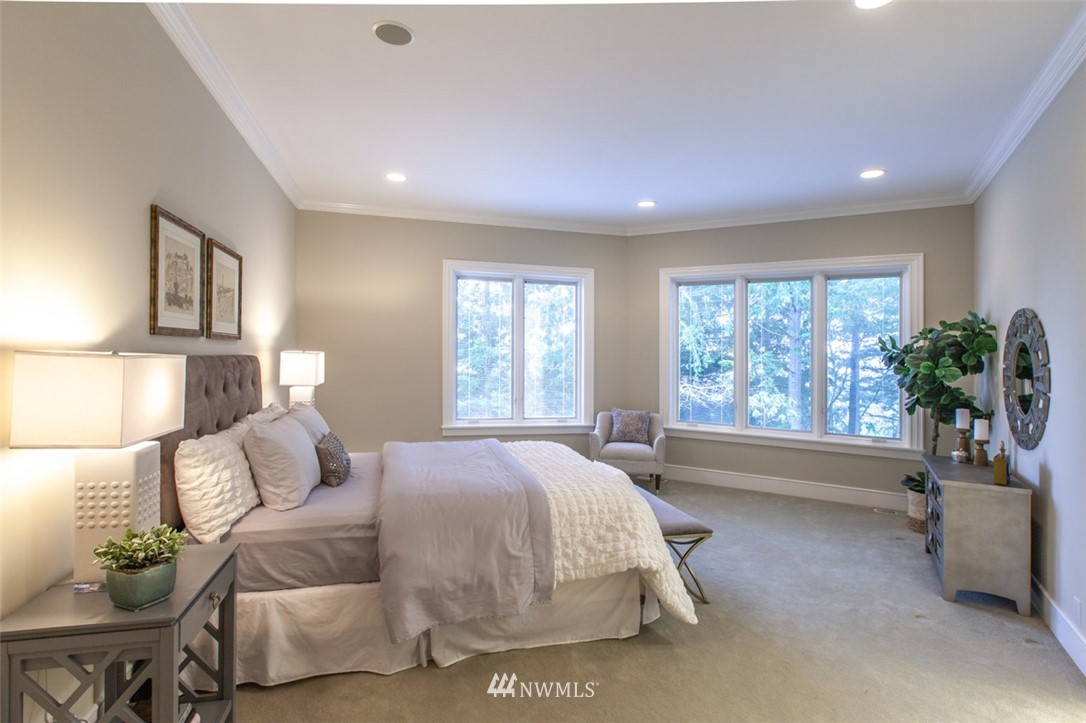 1334 Chuckanut Crest Drive Bellingham, WA 98229 - Photo 21 of 40 a spacious bedroom with a bed and a potted plant