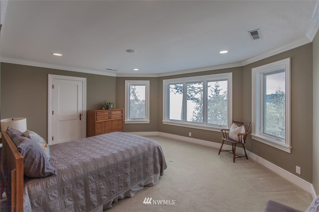 1334 Chuckanut Crest Drive Bellingham, WA 98229 - Photo 36 of 40 a spacious bedroom with a large bed and windows