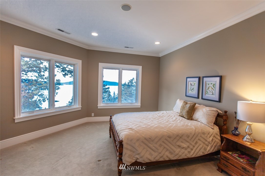 1334 Chuckanut Crest Drive Bellingham, WA 98229 - Photo 38 of 40 a spacious bedroom with a bed and a large window