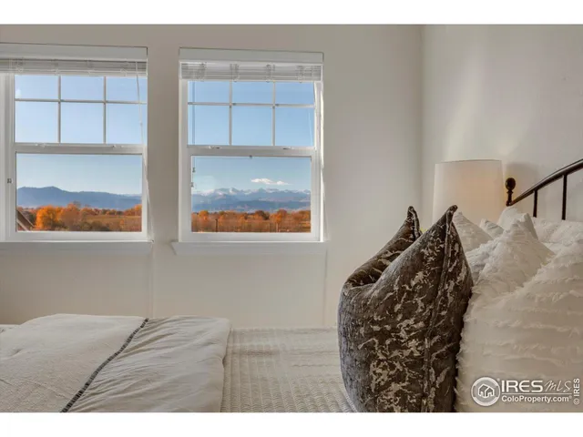 a bedroom with a bed and a view of living room
