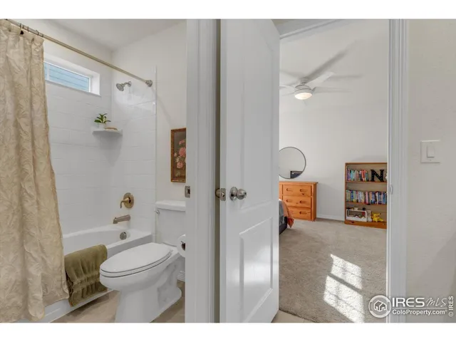 a bedroom with bed and a window