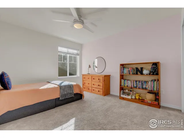 a bedroom with a large bed and chandelier