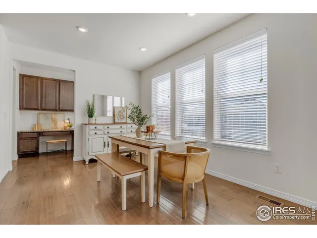 a living room with stainless steel appliances kitchen island granite countertop furniture and a wooden floor