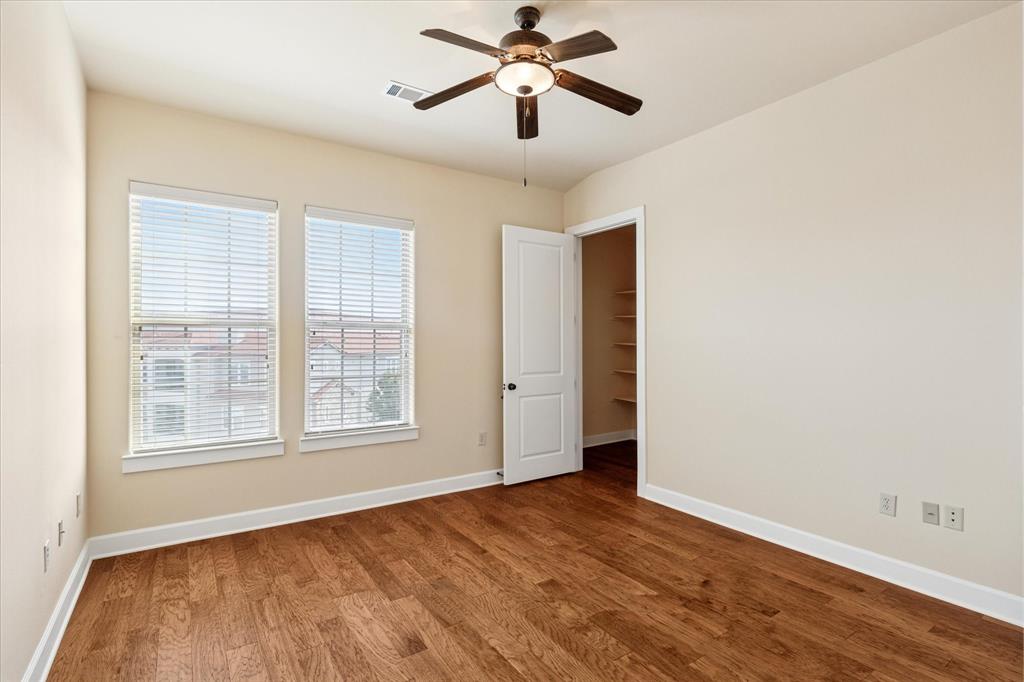 610 Via Ravello, Unit 410 Irving, TX 75039 - Photo 19 of 28 a view of empty room with wooden floor and fan
