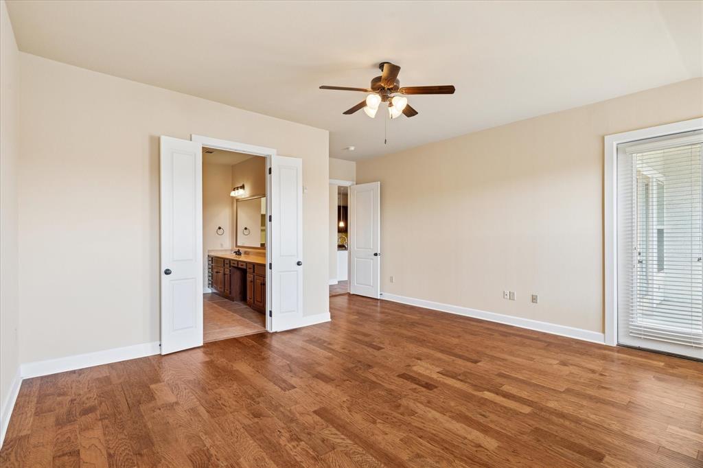 610 Via Ravello, Unit 410 Irving, TX 75039 - Photo 22 of 28 an empty room with wooden floor and natural light
