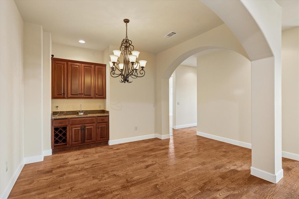 610 Via Ravello, Unit 410 Irving, TX 75039 - Photo 5 of 28 a view of a kitchen with stainless steel appliances granite countertop a refrigerator and a stove top oven
