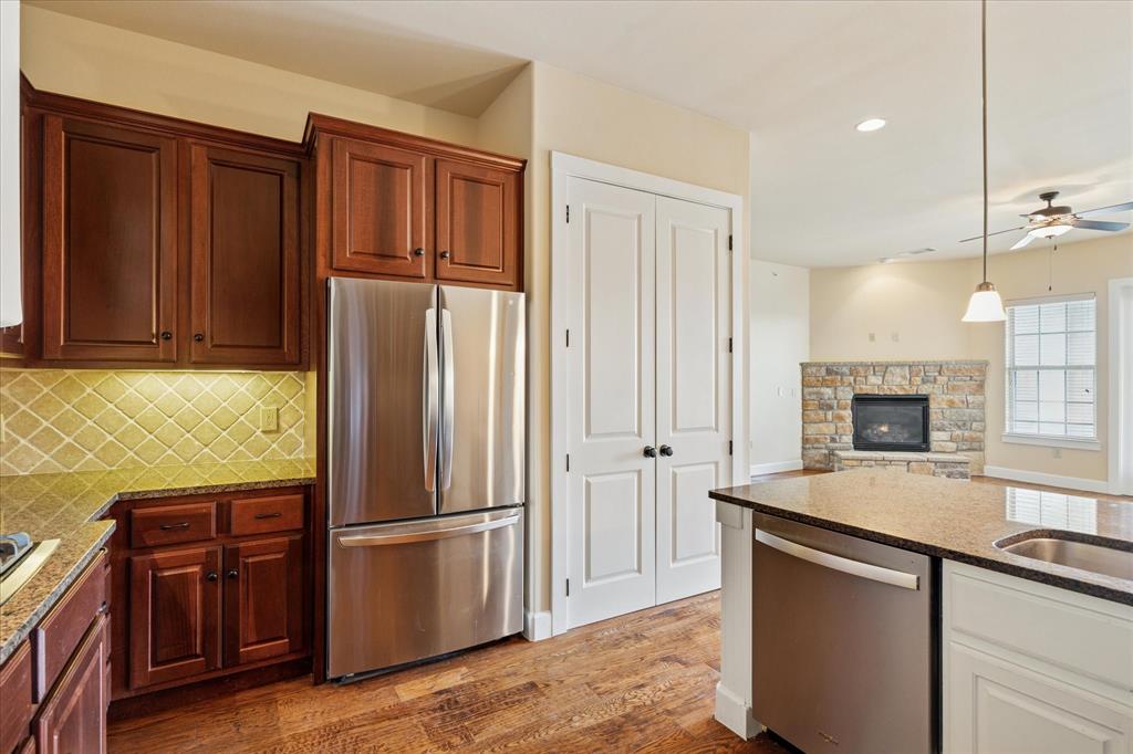 610 Via Ravello, Unit 410 Irving, TX 75039 - Photo 9 of 28 a kitchen with stainless steel appliances granite countertop a refrigerator and a sink