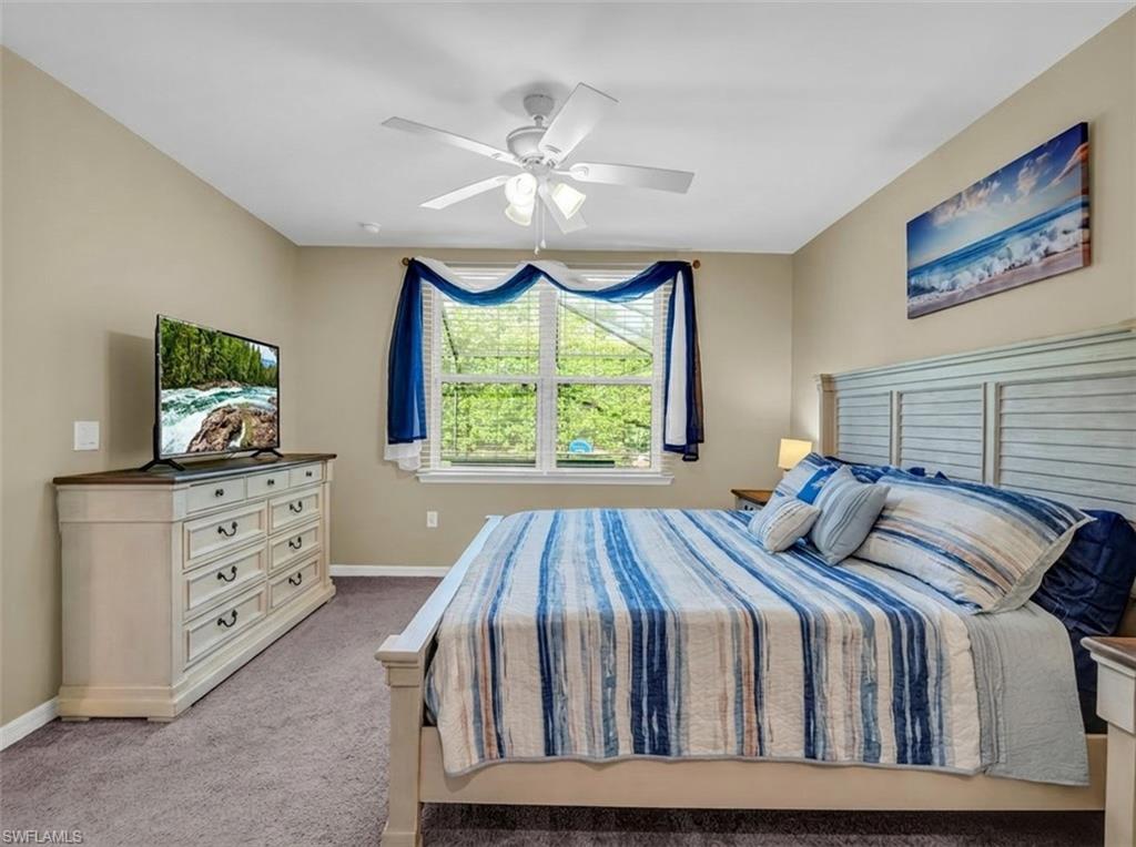 14695 Edgewater Circle Naples, FL 34114 - Photo 20 of 39 a bedroom with a bed and a dresser