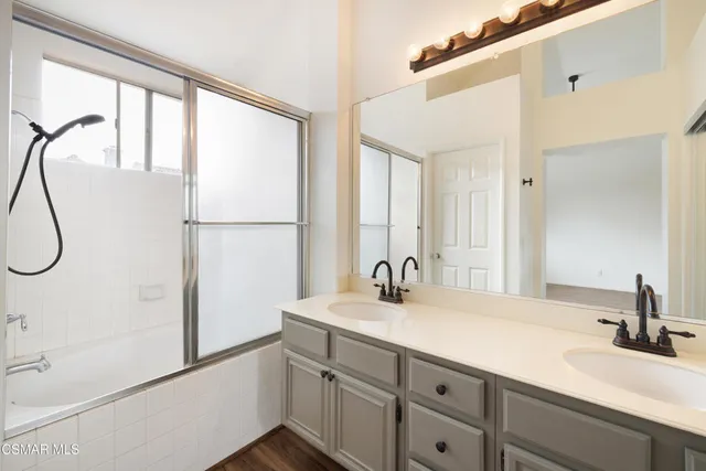 a bathroom with a double vanity sink and mirror