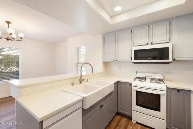 a kitchen with a sink stove and microwave