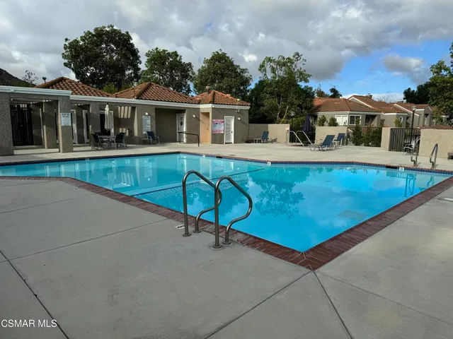 swimming pool view with a seating space