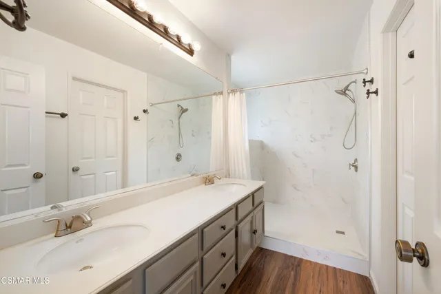 a bathroom with a sink a double vanity and a shower