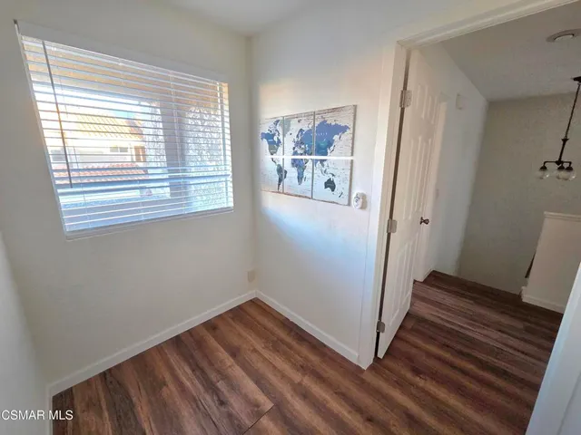 a view of a room with wooden floor and windows