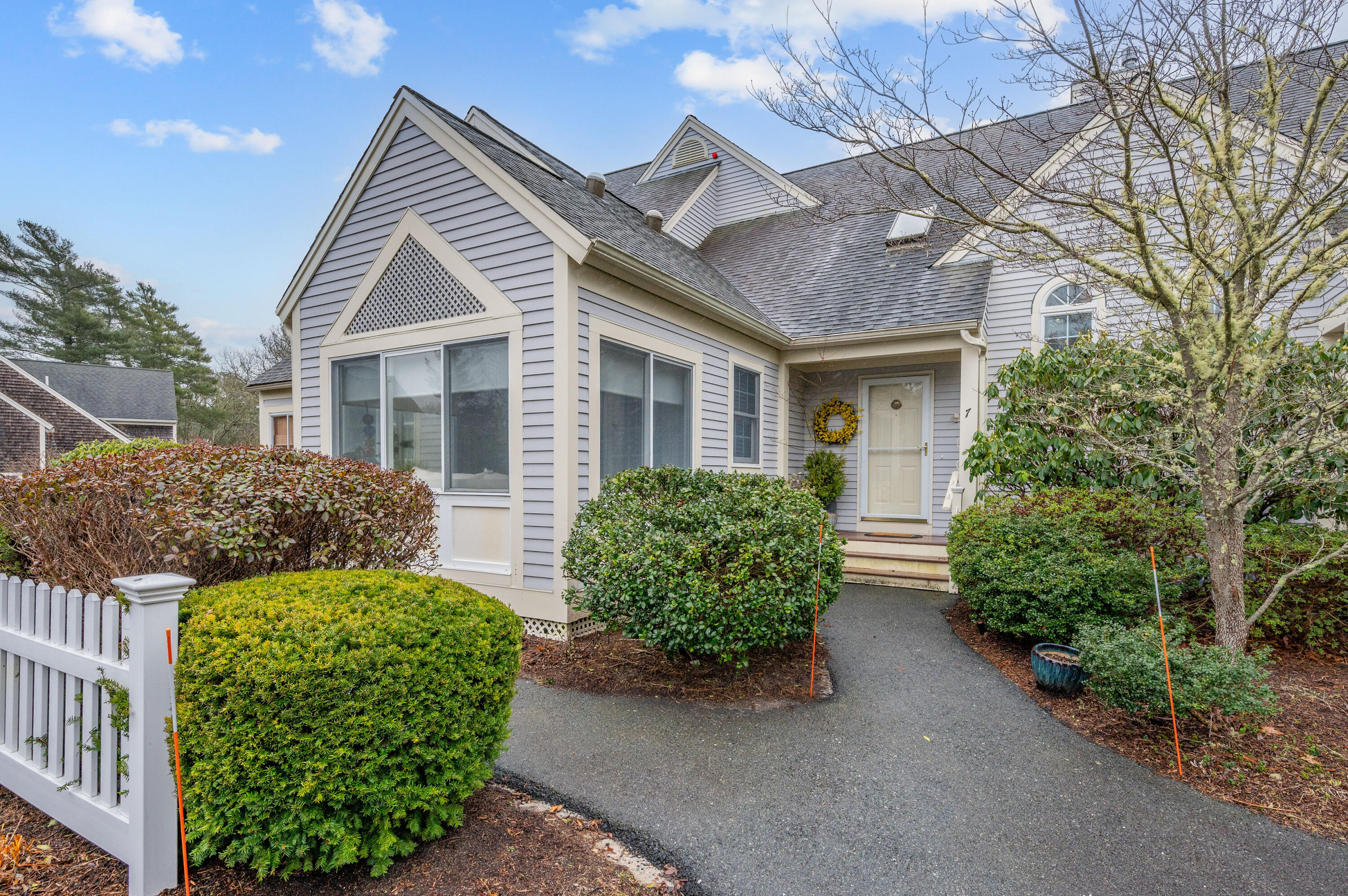 7 Red Cedar Road, Unit 7 Mashpee, MA 02649 - Photo 3 of 37 front view of a house with a garden