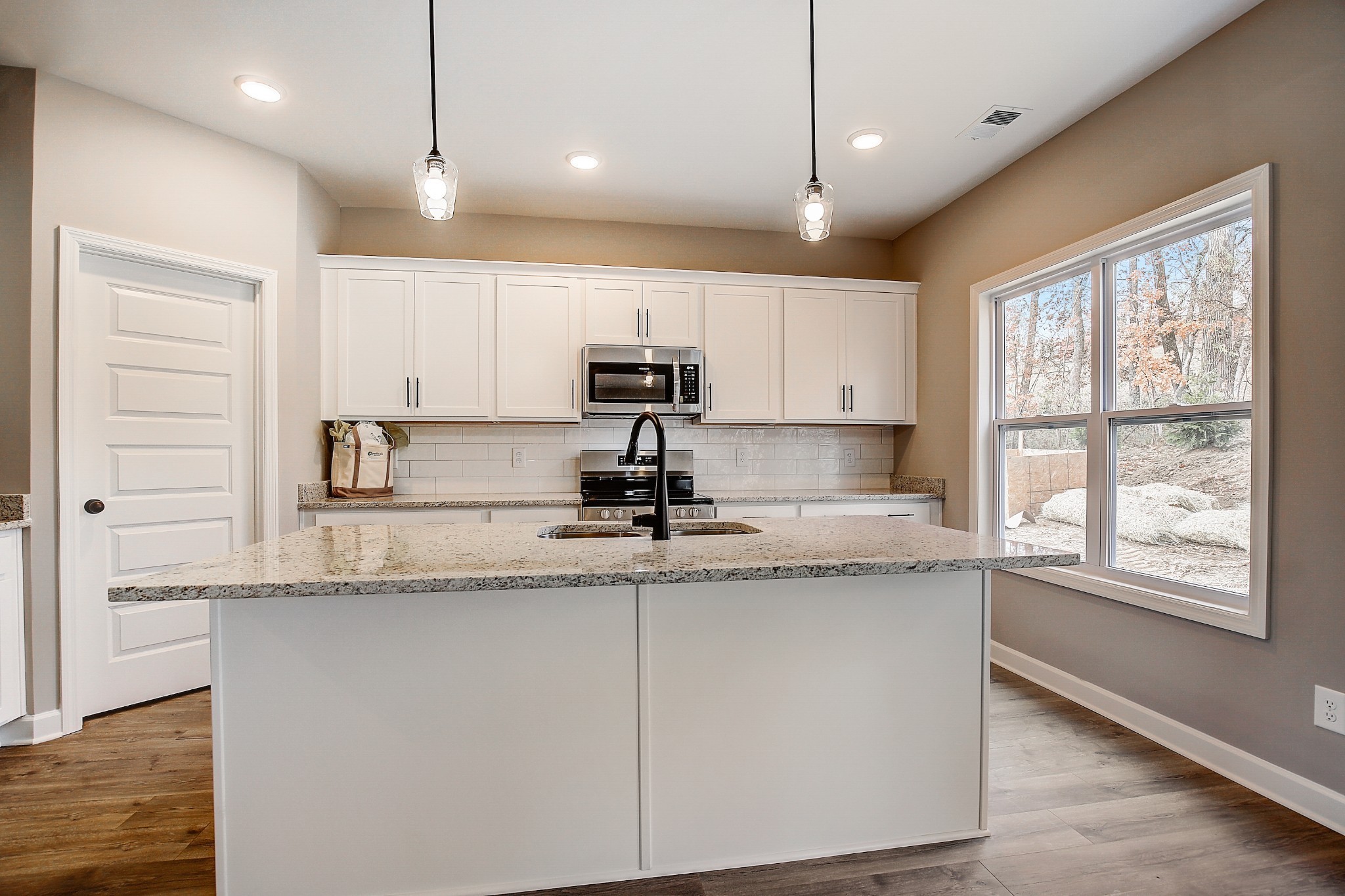 1770 Fenway Loop Antioch, TN 37013 - Photo 12 of 32 a kitchen with granite countertop kitchen island a counter space a sink stainless steel appliances and cabinets