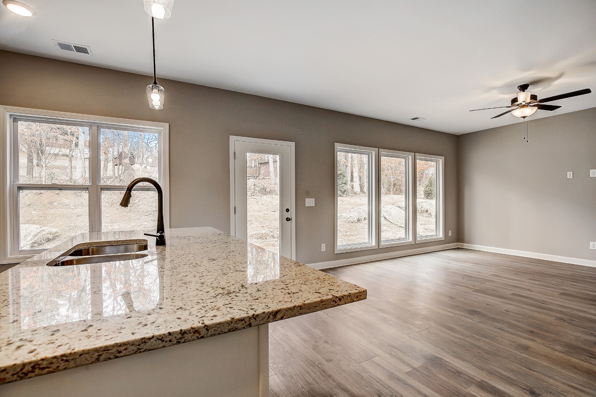 1770 Fenway Loop Antioch, TN 37013 - Photo 16 of 32 a kitchen with granite countertop a stove a sink and wooden floors