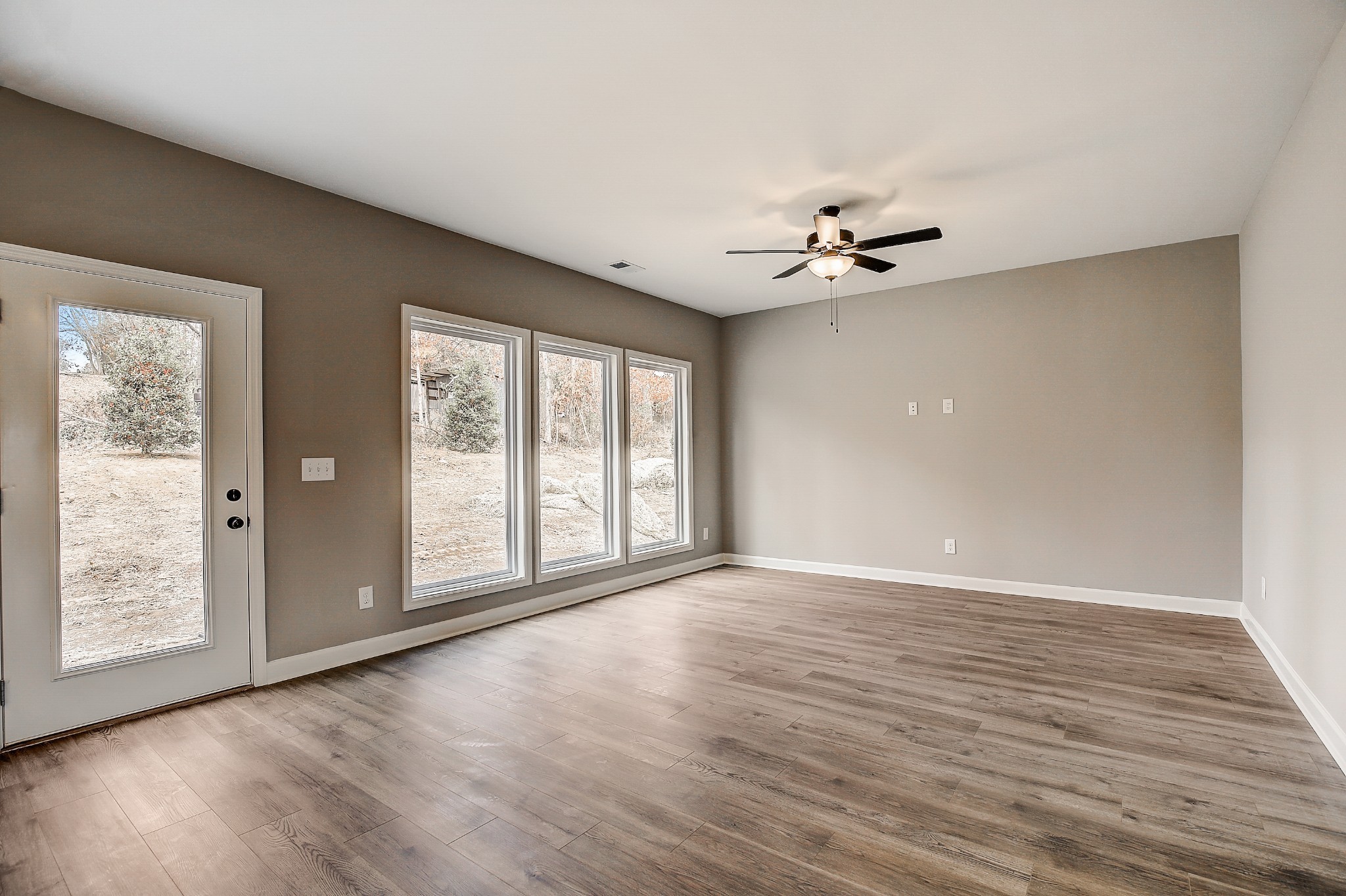1770 Fenway Loop Antioch, TN 37013 - Photo 8 of 32 a view of an empty room with a window and wooden floor