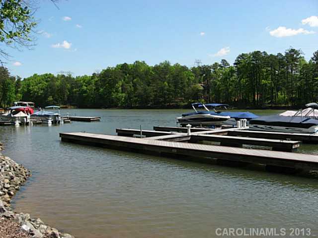 1312 Reflection Pointe Boulevard, Unit 331 Belmont, NC 28012 - Photo 6 of 11 a view of a lake with lawn chairs