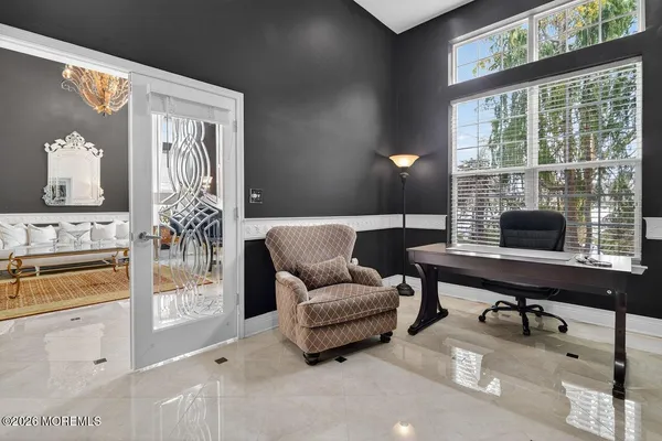 a spacious bedroom with a bed and a flat screen tv