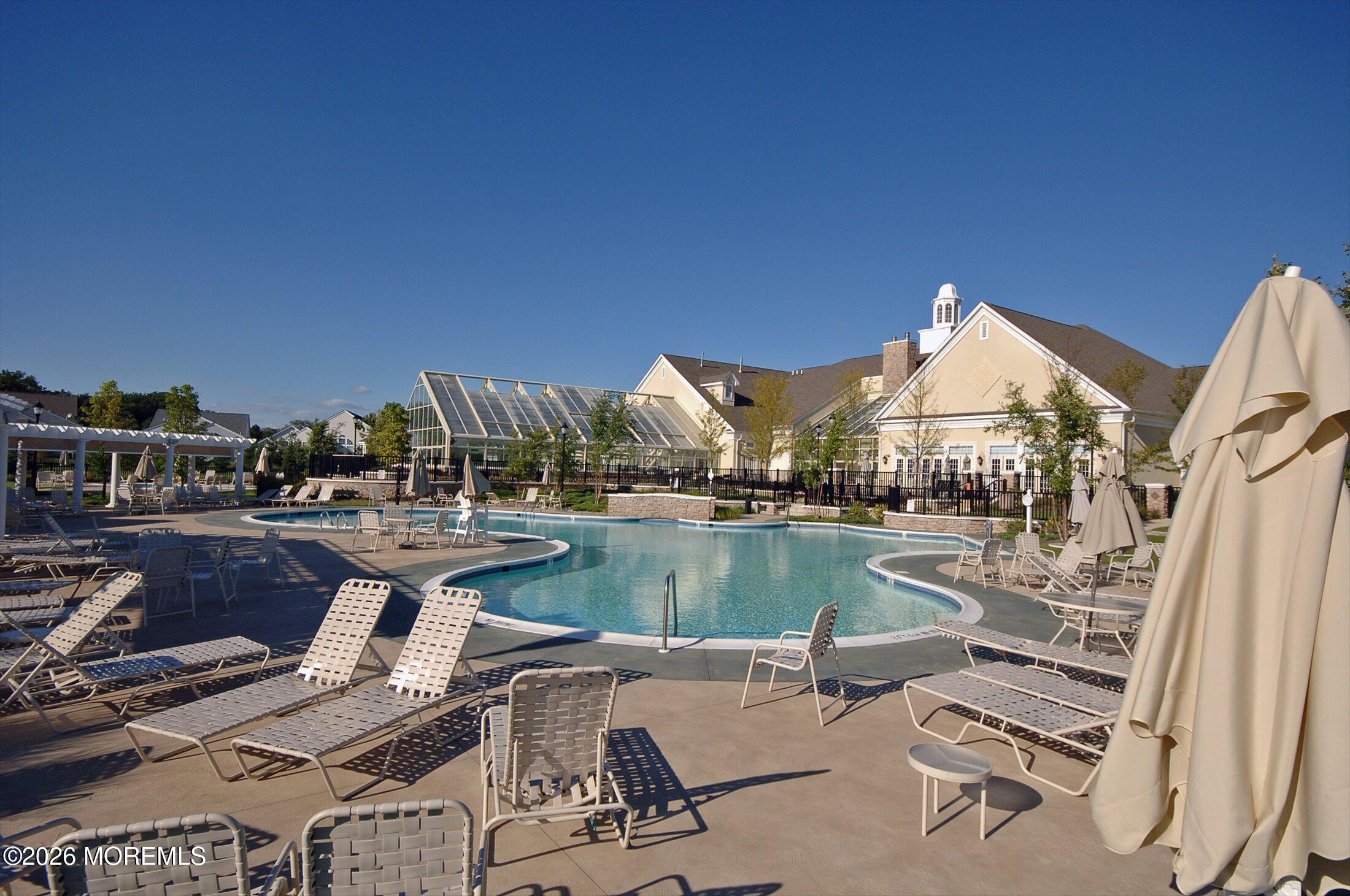 38 Park Ridge Way Jackson, NJ 08527 - Photo 8 of 22 a view of a lake with couches chairs and umbrella