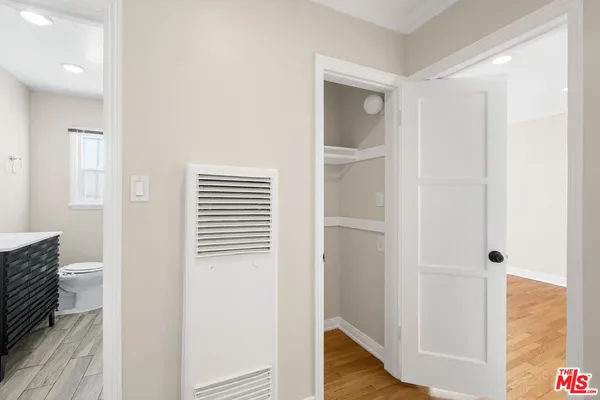 a view of hallway with wooden floor
