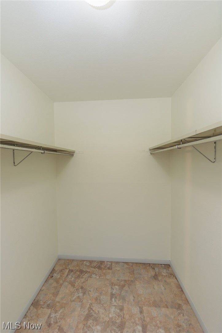 6472 State Road, Unit J19 Parma, OH 44134 - Photo 26 of 33 Walk in closet with light tile floors