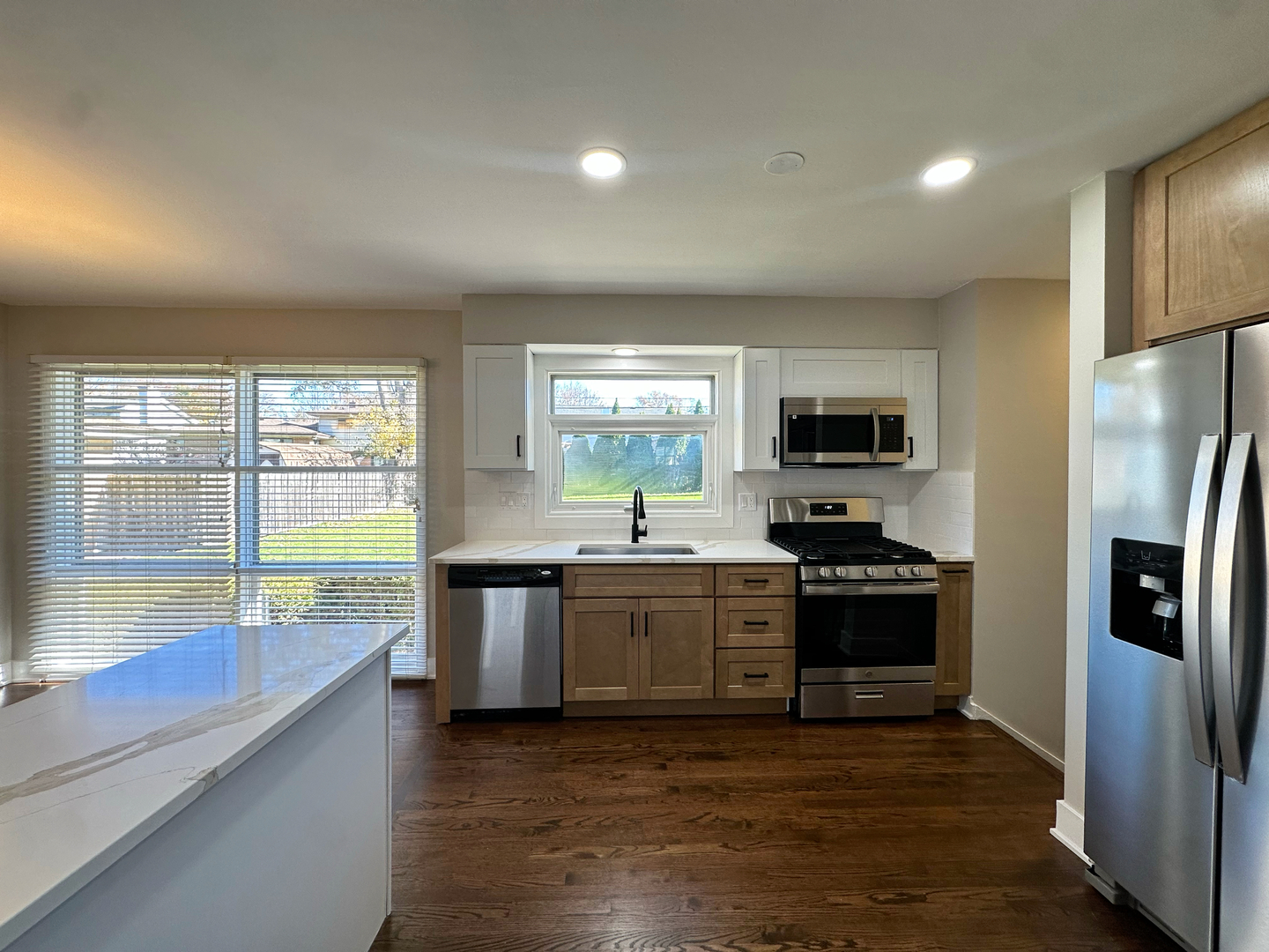 909 South Emerson Street Mount Prospect, IL 60056 - Photo 15 of 45 a large kitchen with stainless steel appliances granite countertop a stove a sink and a refrigerator