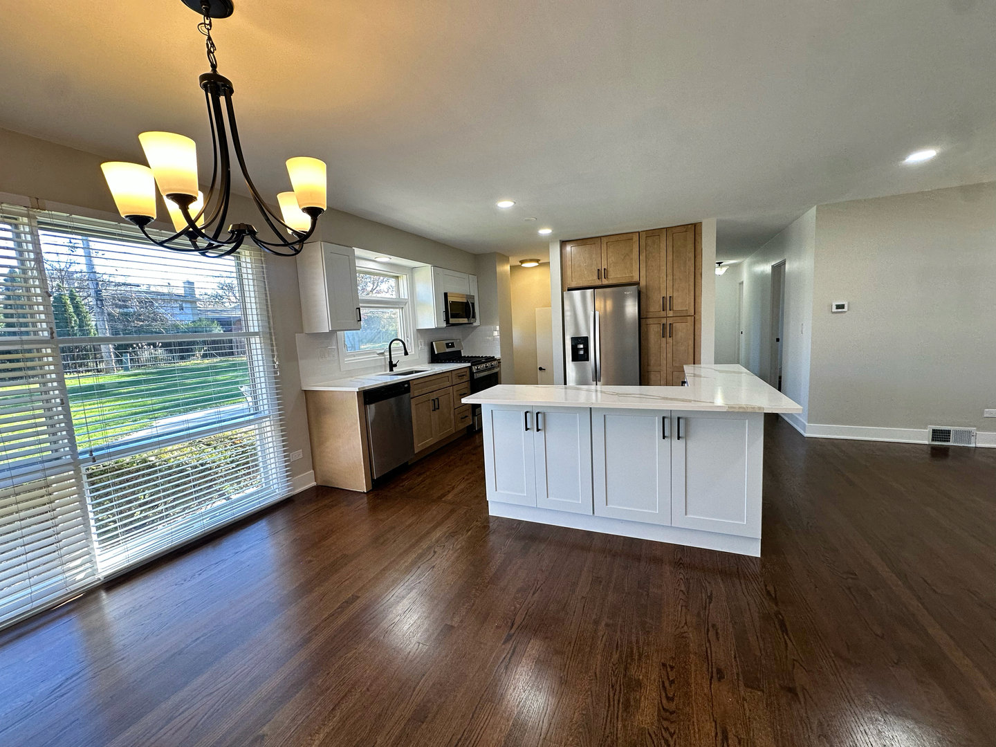 909 South Emerson Street Mount Prospect, IL 60056 - Photo 17 of 45 a kitchen with stainless steel appliances granite countertop a sink dishwasher a refrigerator and a fireplace with wooden floor