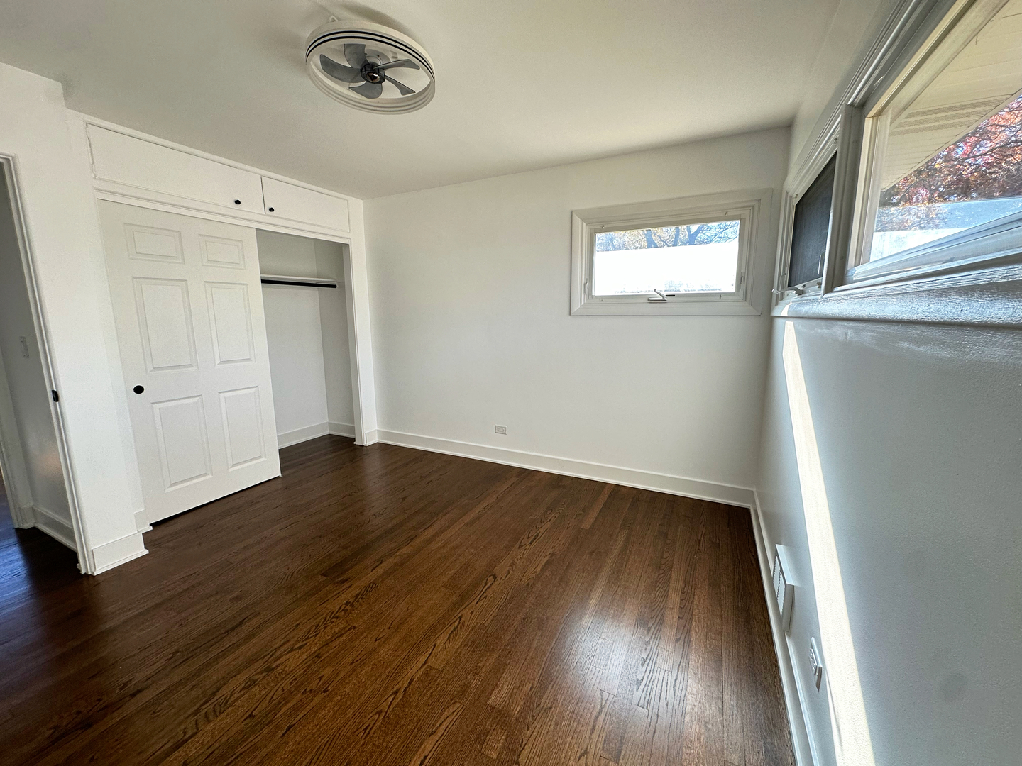 909 South Emerson Street Mount Prospect, IL 60056 - Photo 27 of 45 an empty room with wooden floor cabinet and windows