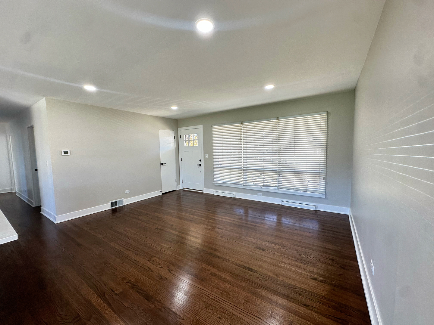 909 South Emerson Street Mount Prospect, IL 60056 - Photo 4 of 45 an empty room with wooden floor and windows