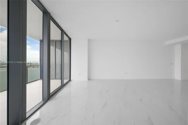 a view of a hallway with a white walls and a bathroom