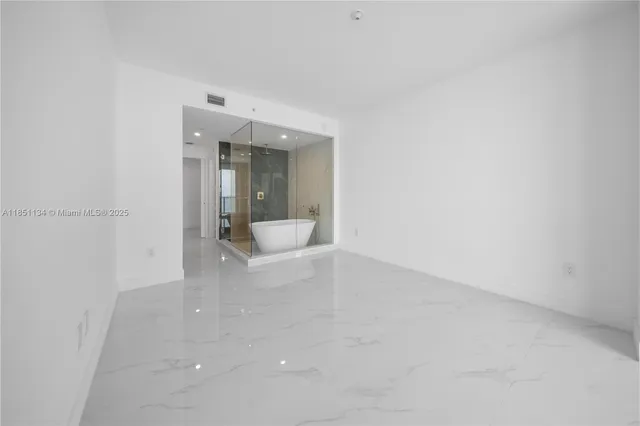 a bathroom with a shower and a sink