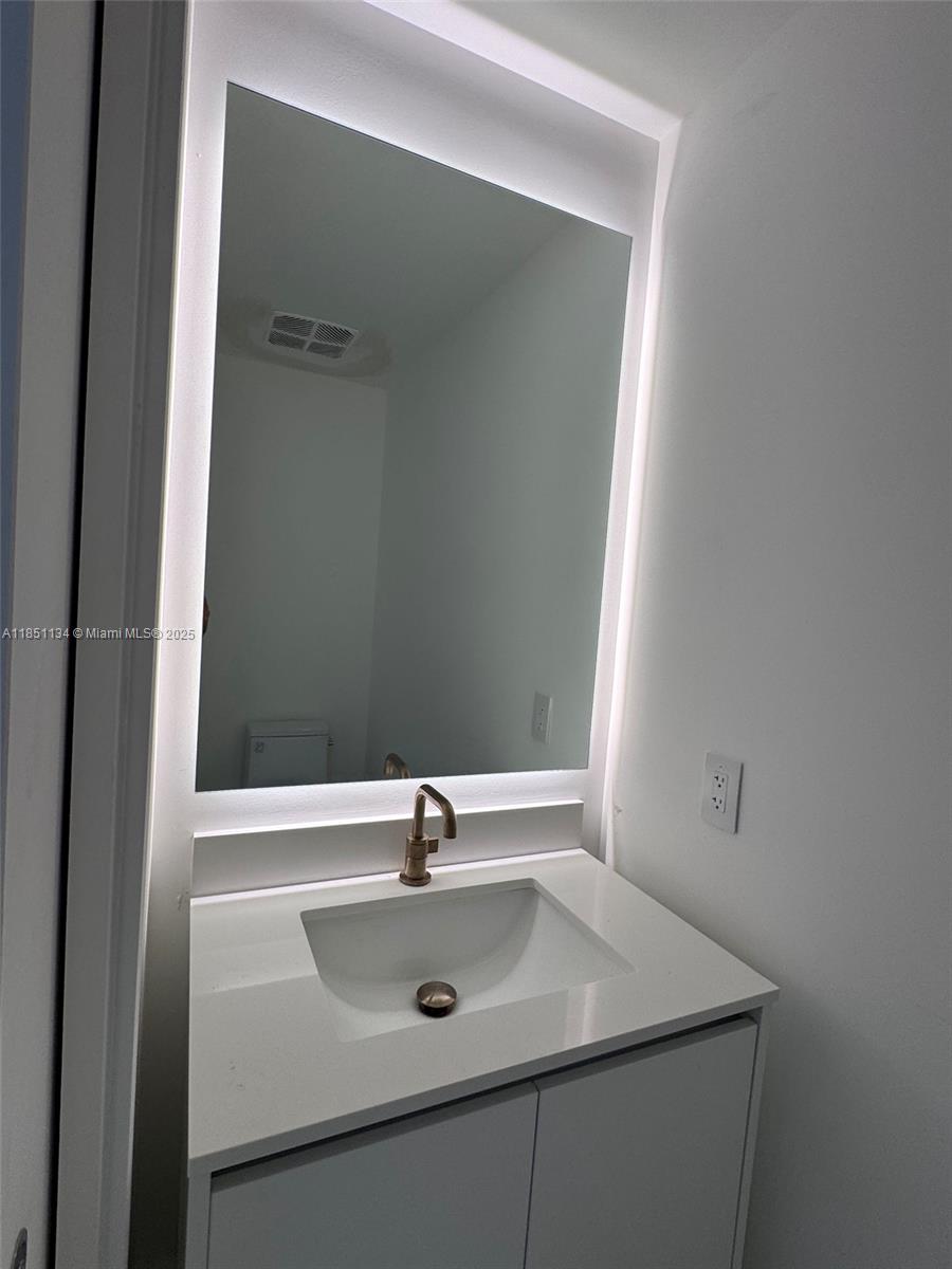 700 Northeast 24th Street, Unit 2503 Miami, FL 33137 - Photo 24 of 61 a bathroom with a sink and a mirror