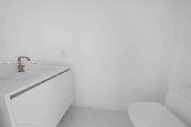 a bathroom with a granite countertop sink a toilet and bathtub