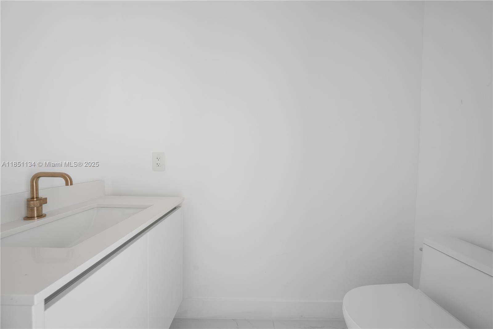 700 Northeast 24th Street, Unit 2503 Miami, FL 33137 - Photo 26 of 61 a bathroom with a toilet sink and mirror