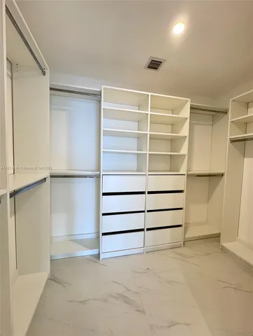a bathroom with a double vanity sink mirror and shower