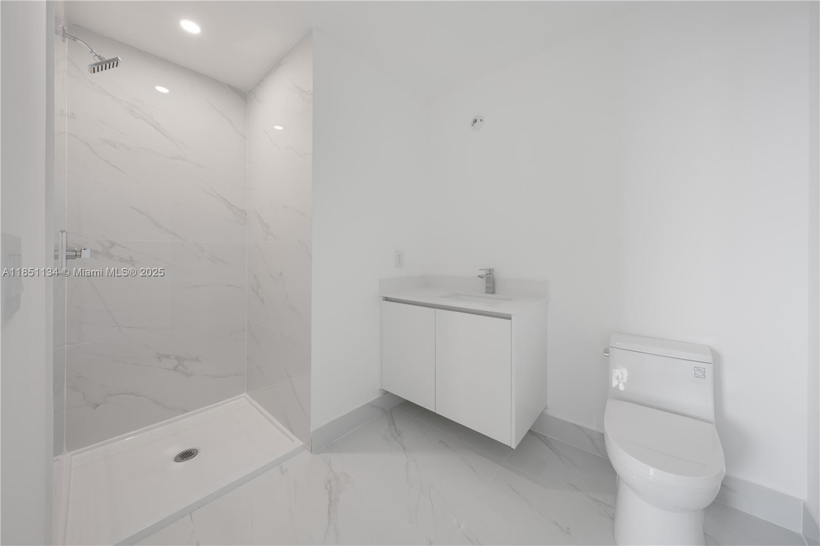 700 Northeast 24th Street, Unit 2503 Miami, FL 33137 - Photo 36 of 61 a bathroom with a sink a toilet and shower