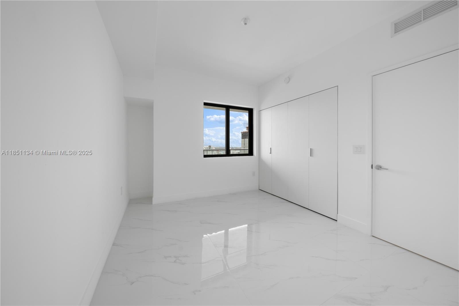 700 Northeast 24th Street, Unit 2503 Miami, FL 33137 - Photo 37 of 61 an empty room with windows and closet