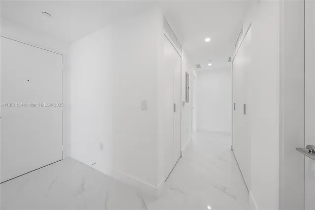 a roof deck with couches and potted plants