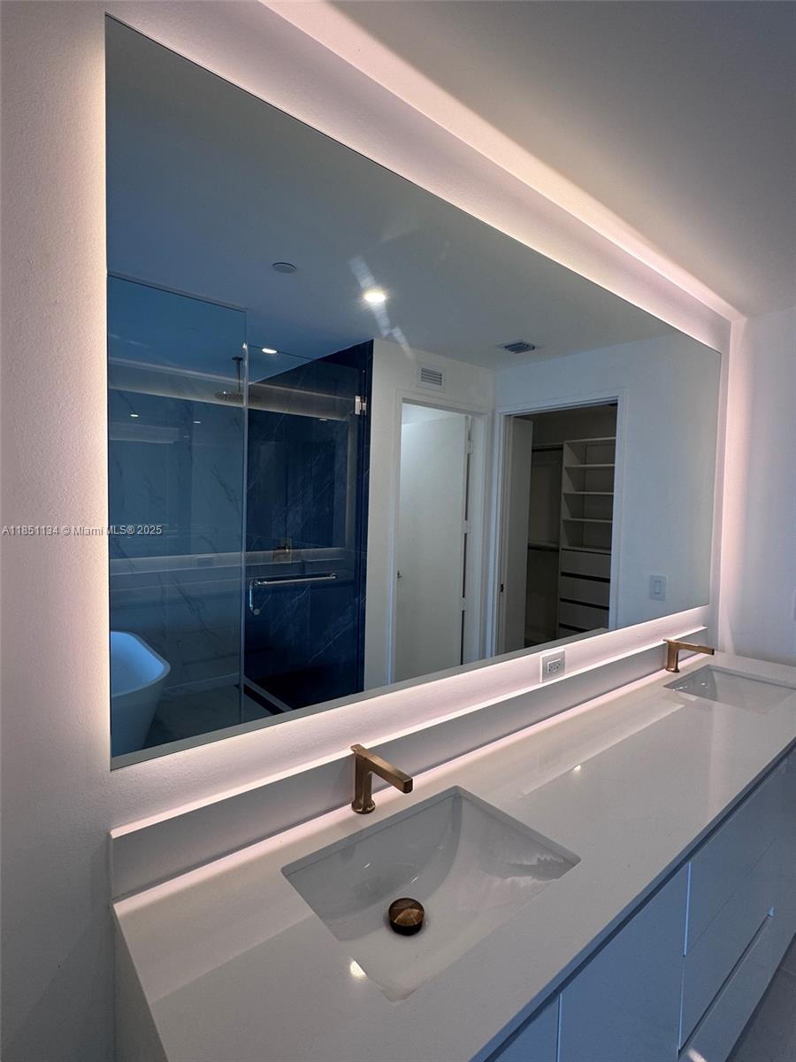 700 Northeast 24th Street, Unit 2503 Miami, FL 33137 - Photo 41 of 61 a bathroom with a sink and a mirror