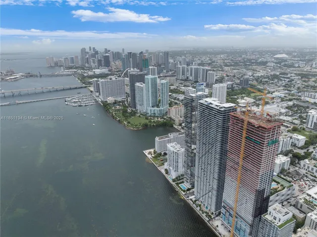 a lobby with furniture and potted plants