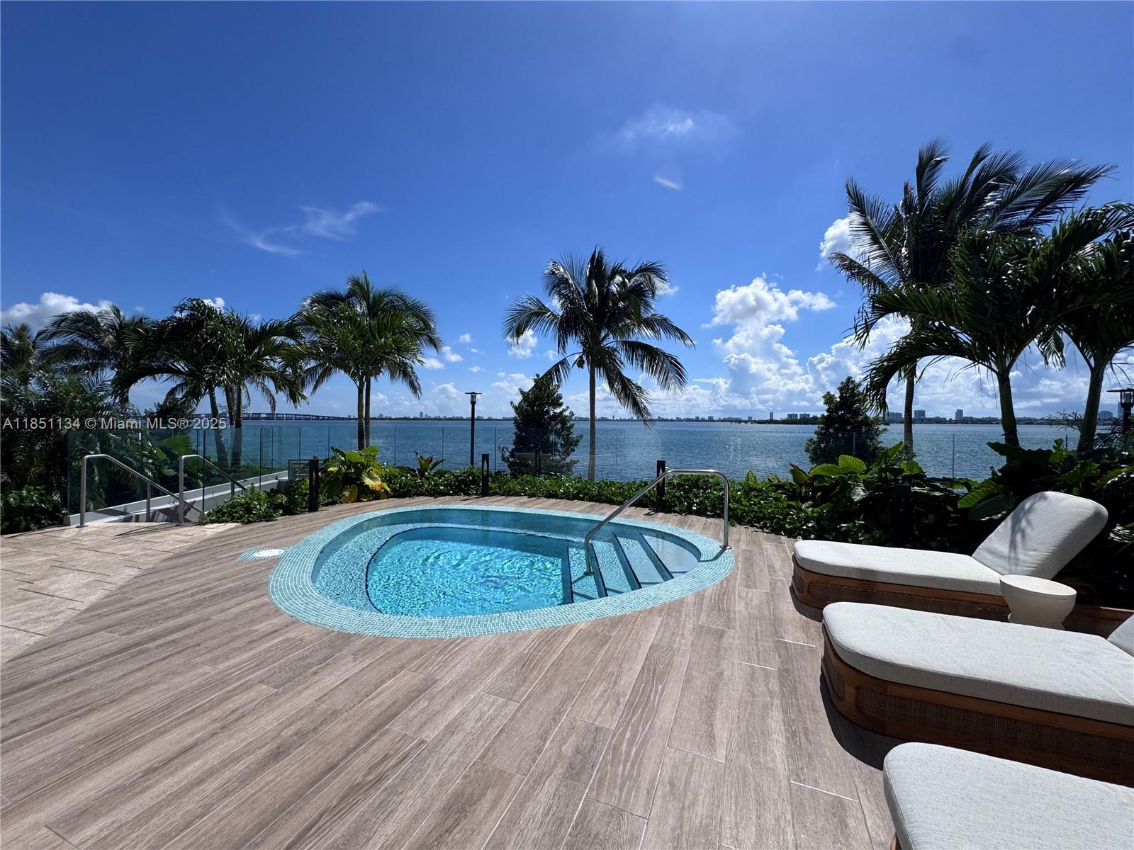 700 Northeast 24th Street, Unit 2503 Miami, FL 33137 - Photo 48 of 61 a swimming pool with outdoor seating and yard