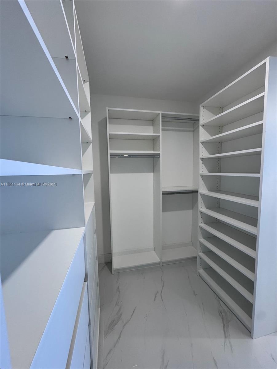 700 Northeast 24th Street, Unit 2503 Miami, FL 33137 - Photo 56 of 61 a view of walk in closet with empty racks