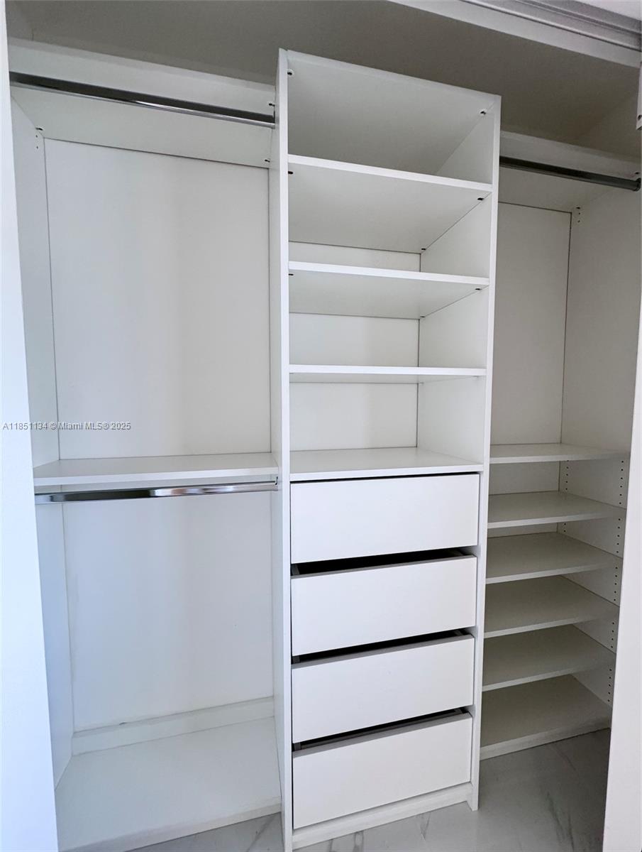 700 Northeast 24th Street, Unit 2503 Miami, FL 33137 - Photo 57 of 61 a view of walk in closet with empty racks