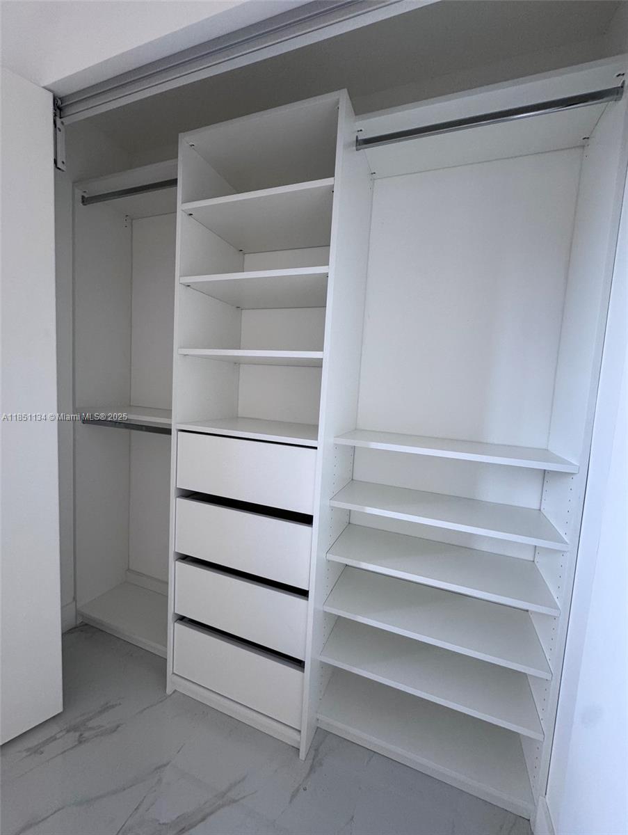 700 Northeast 24th Street, Unit 2503 Miami, FL 33137 - Photo 58 of 61 a view of walk in closet with empty racks