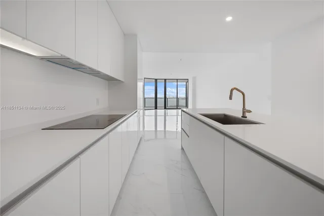 a hallway with a sink and chandelier