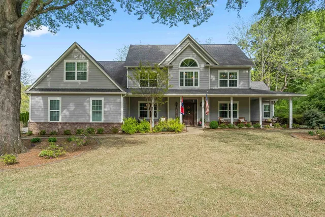 a front view of a house with a yard
