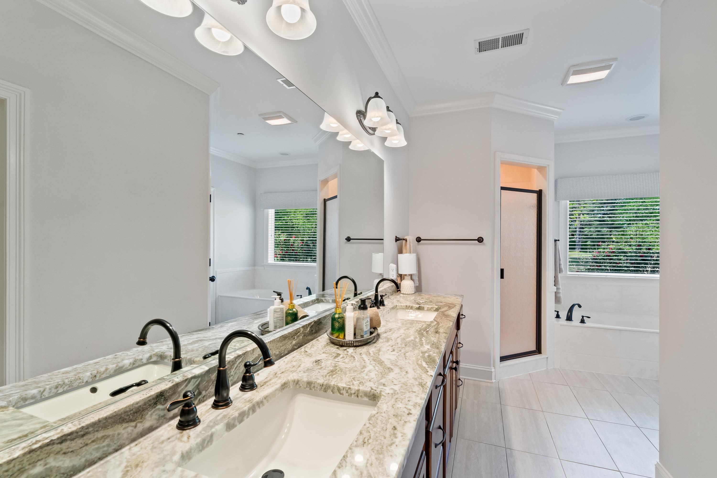 210 Poplar Acres Road Piperton, TN 38017 - Photo 19 of 40 a bathroom with a granite countertop double vanity sink a mirror and a bathtub