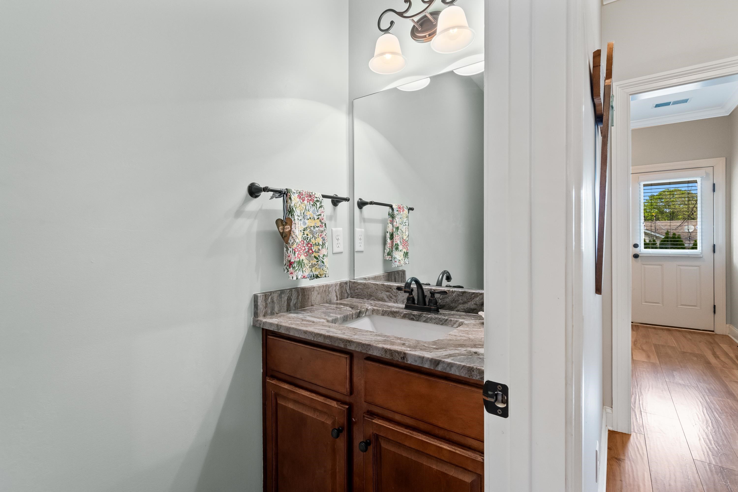 210 Poplar Acres Road Piperton, TN 38017 - Photo 23 of 40 a bathroom with a granite countertop sink and a mirror