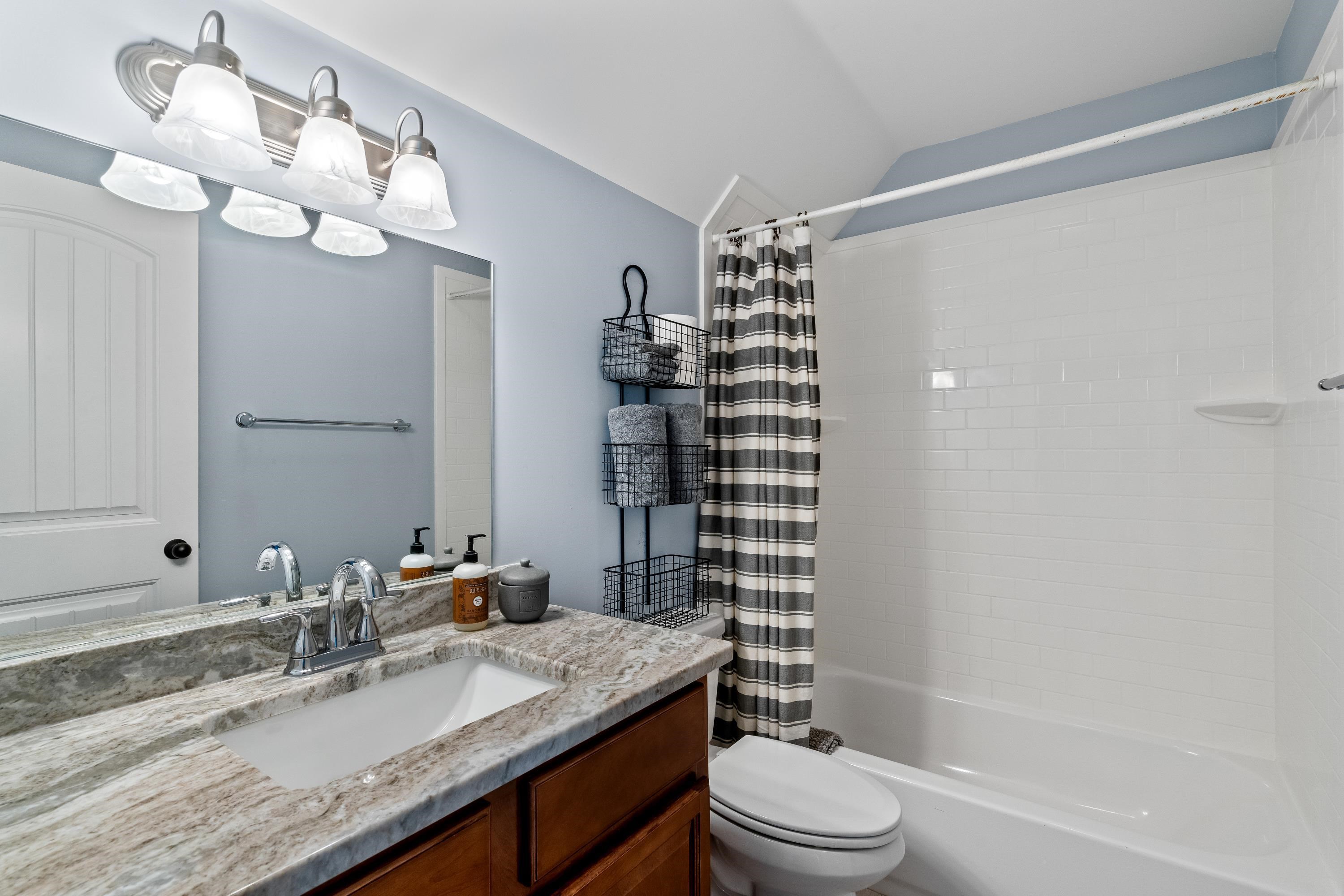 210 Poplar Acres Road Piperton, TN 38017 - Photo 25 of 40 a bathroom with a granite countertop bathtub sink vanity mirror and toilet